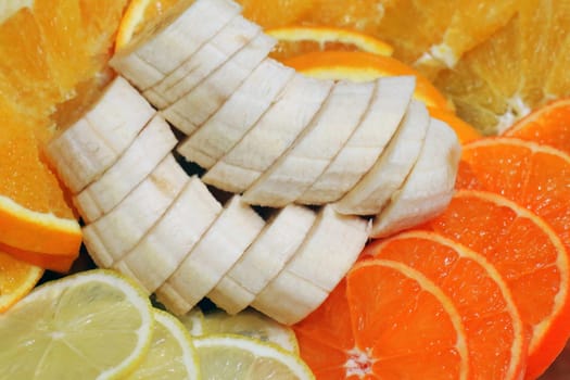 slicing assorted banana orange lemon for the entire frame macro