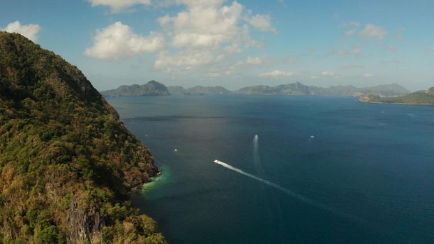 Cove with tropical rocky islands covered with rainforest, sea with blue water, aerial view. El nido, Philippines, Palawan. Tropical Mountain Range