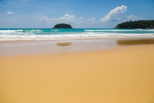 Beautiful sea Sunny landscape on the beach. Light waves of blue color spread all over the beach smoothly smoothing the Golden sand.