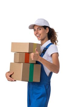 Portrait of happy smiling delivery woman with stack of boxes showing thumb up isolated on white background