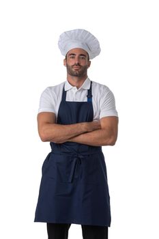 Portrait of male cook in apron and hat with crossed arms on chin and looking up isolated on white background