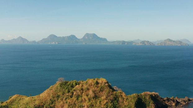 Blue sea and tropical beach, aerial drone. Nacpan, El Nido, Palawan, Philippine Islands. Seascape with tropical beach and islands. Summer and travel vacation concept