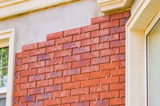 Clinker brick of brown color. Clinker thermal panels for finishing the facade of the house. Tiles for outdoor decoration