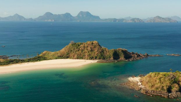 Wide sand beach Nacpan Beach, aerial view. El Nido, Palawan, Philippine Islands. Seascape with tropical beach and islands. Summer and travel vacation concept