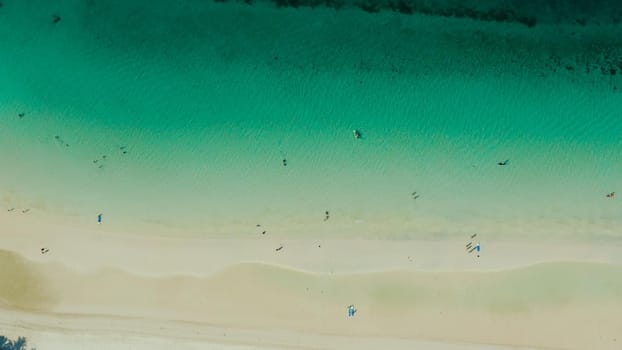 Tropical sandy beach with wave and turquoise water,copy space for text, aerial view. Ocean with waves and tropical beach. Summer and travel vacation concept