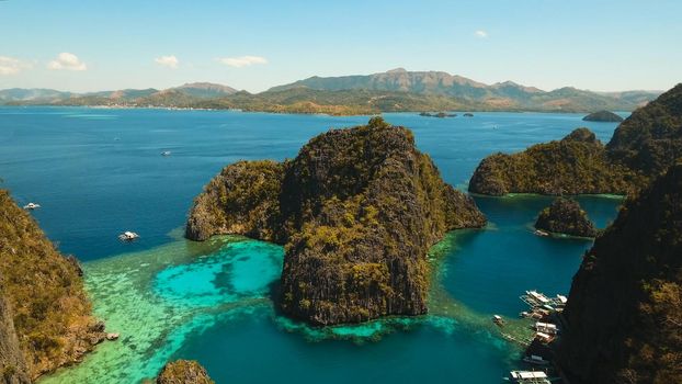 Tropical lagoon with azure water, beach by the Kayangan Lake, Philippines. Aerial view Coron island, with cove, bay at Kayangan lake. Lagoon with sailing boats. Aerial video. Philippines. Travel concept