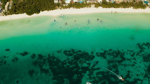Tropical white sand beach in a lagoon with turquoise water on Boracay Island, Philippines., aerial view. Seascape with beach on tropical island. Summer and travel vacation concept.