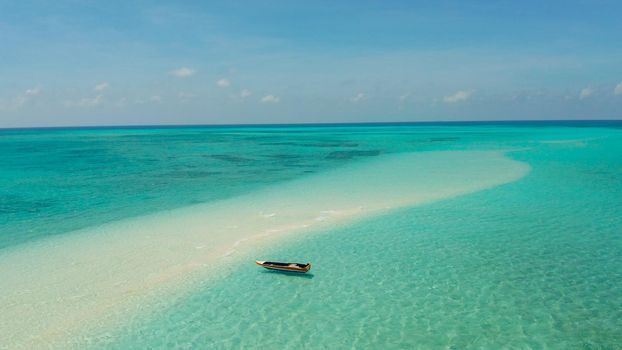 Sand bar in transparent turquoise water top view. Tropical beach with tourists. Mansalangan sandbar, Balabac, Palawan, Philippines. Summer and travel vacation concept