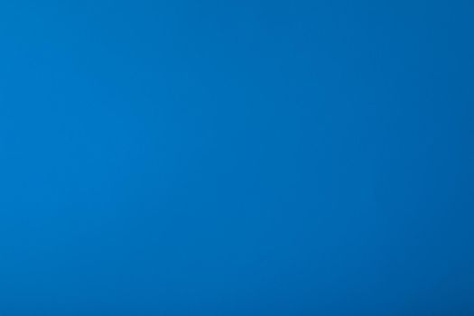 Blue background with paper texture, horizontal, blank space.