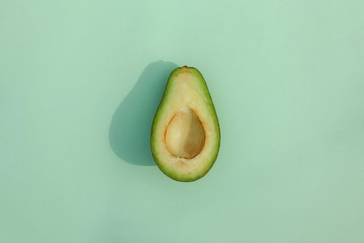 avocado on a colored background pattern top view