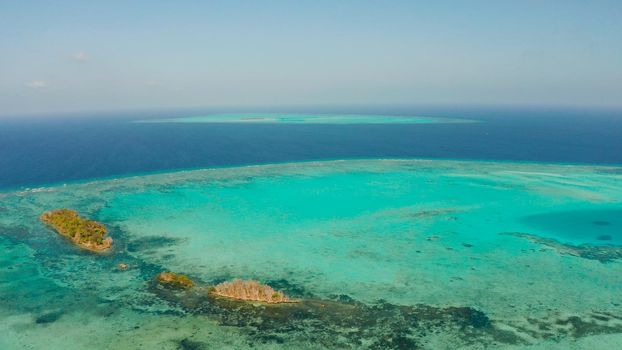 Tropical islands surrounded by an atoll and a coral reef view from above. Balabac, Philippines. Summer and travel vacation concept