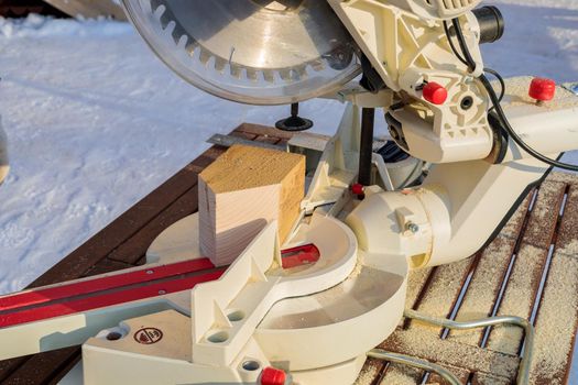 Circular saw on wood beams. Circular saw for working with wood. Saw for sawing a bar at different angles