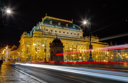 Czech Republic, Prague, April 16, 2016, theater building with evening lighting. Long lines of lights of cars moving along the road.