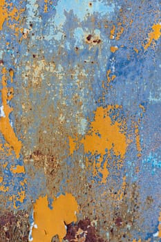 Rust, steel, background. Peeling off old paint Blue yellow white