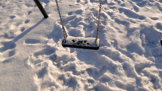 swing with snow cover in wintertime