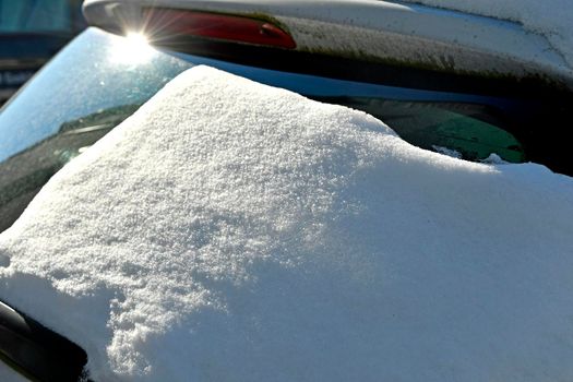 snow on a front window of a car