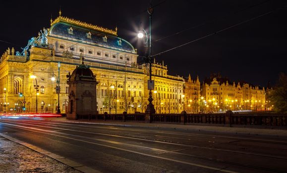 Czech Republic, Prague, April 16, 2016, theater building with evening lighting. Long lines of lights of cars moving along the road.
