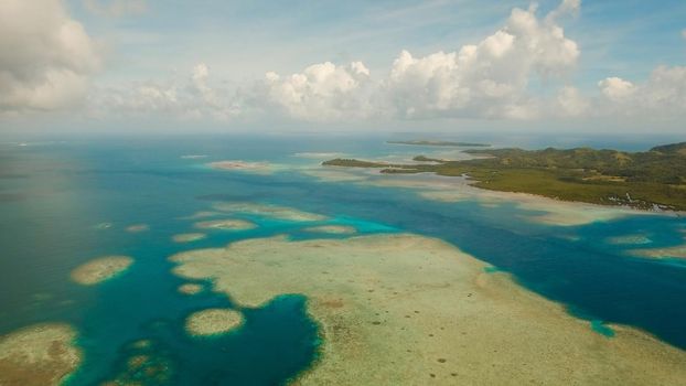 Aerial view: beach, tropical island, sea bay and lagoon, Siargao. Tropical landscape hill, clouds and mountains rocks with rainforest. Azure water of lagoon. Shore Landscape Bay. Seascape. Travel concept.
