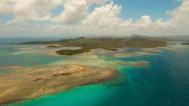 Aerial view: beach, tropical island, sea bay and lagoon, Siargao. Tropical landscape hill, clouds and mountains rocks with rainforest. Azure water of lagoon. Shore Landscape Bay. Aerial video.Seascape.