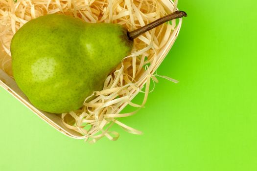 pear basket on a green background close-up. High quality photo
