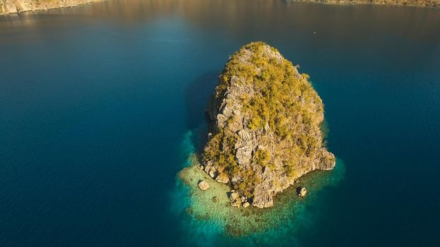 Aerial view: beach, tropical island, sea bay and lagoon, Palawan. Lagoon with blue, azure water in the middle of small islands and rocks. Busuanga. Seascape, tropical landscape. Philippines.