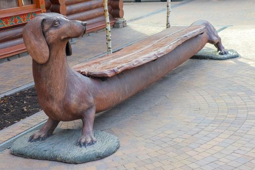 wooden bench in the shape of a dog. High quality photo