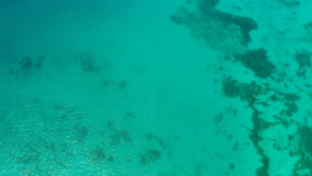 Sea water surface in lagoon, copy space for text, aerial view. Top view transparent turquoise ocean water surface. background texture