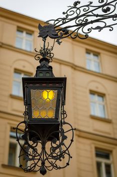 Luxurious antique street lamp made of black metal. Refined style, forging.