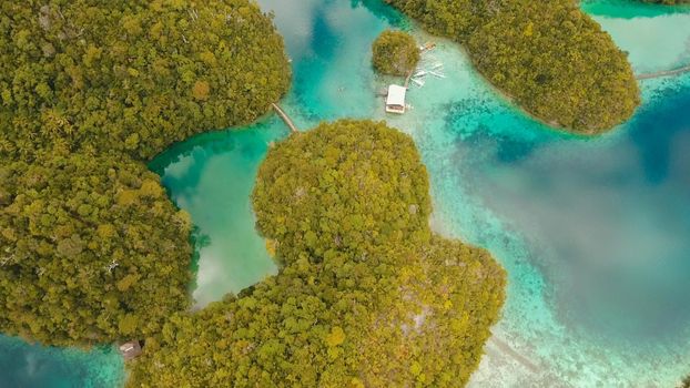 Aerial view: beach, tropical island, sea bay and lagoon, Siargao. Tropical landscape hill, clouds and mountains rocks with rainforest. Azure water of lagoon. Shore Landscape Bay. Travel concept.
