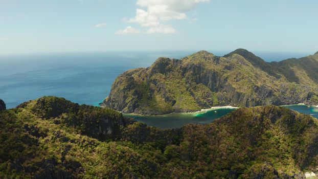Bay and the tropical islands. Seascape with tropical rocky islands, ocean blue wate, aerial view. islands and mountains covered with tropical forest. El nido, Philippines, Palawan. Tropical Mountain Range