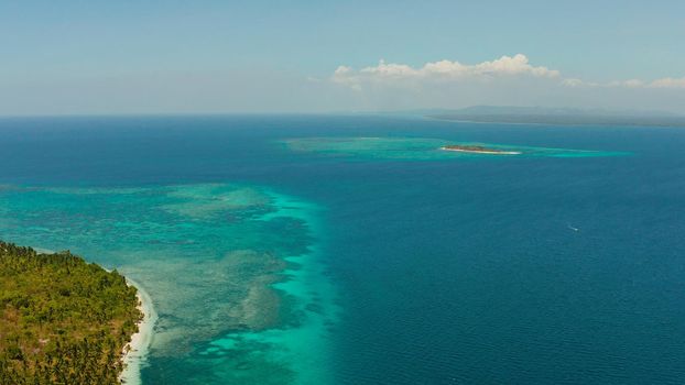 Sandy beach and tropical islands by atoll with coral reef, top view. Patongong Island with sandy beach. Summer and travel vacation concept.