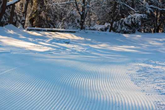 The geometry of the slope lines on the ski slope, left by the snowcat from flat strips.