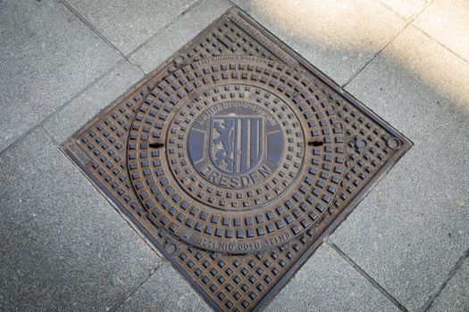 Dresden, Germany, April 18, 2018: Manhole cover made of cast iron of the city sewer system of Dresden.
