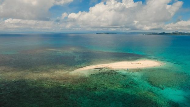 Aerial view of beautiful sand tropical island with white sand beach and tourists. White sand island. Seascape: ocean and beautiful beach paradise. Philippines, Siargao. Travel concept.