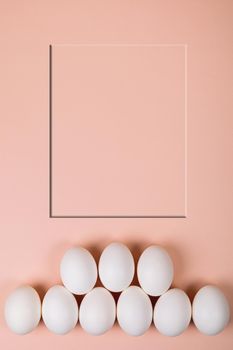 Easter eggs white on a pink background with place for text. Various compositions in a row, top, side, bottom.