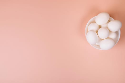 Easter eggs white on a pink background with place for text. Various compositions in a row, top, side, bottom.