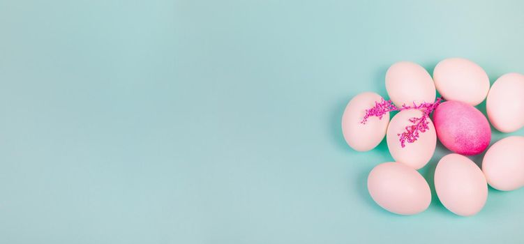 Easter. White eggs with a red egg and a twig on a uniform blue background. Place for text.