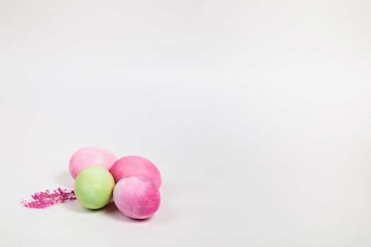 Easter. Multi-colored eggs with twigs, on a white background with a place for text. View from above