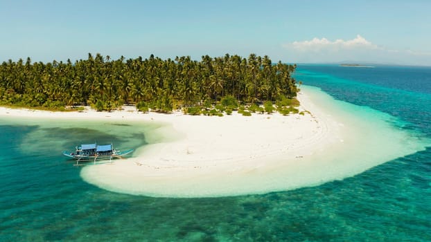 Tropical island with sandy beach by atoll with coral reef and blue sea, aerial view. Patongong Island with sandy beach. Summer and travel vacation concept.