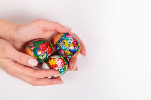 Easter. Khokhloma eggs in the hands of a girl, on a light background. Place for text. Egg Stickers