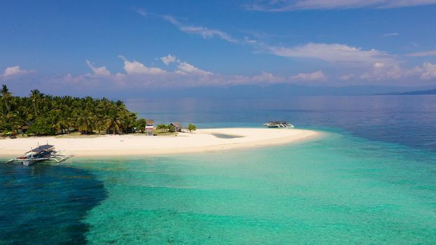 Beautiful beach. View of nice tropical beach with palms around. Holiday and vacation concept. Tropical beach. Digyo Island, Philippines.