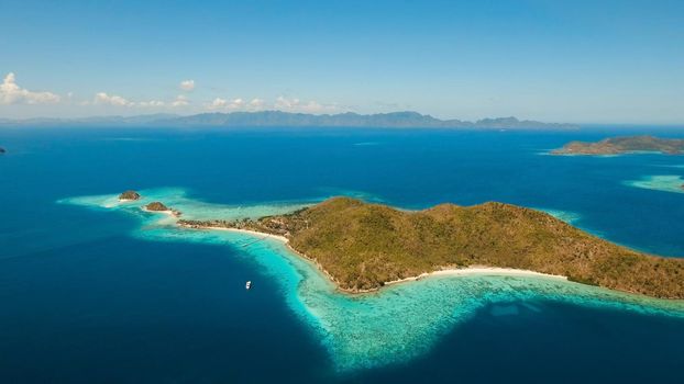 Aerial view lagoon with blue, azure water in middle small islands and rocks. Beach, tropical island, sea bay and lagoon, mountains with forest, Palawan, Coron. Busuanga. Seascape, tropical landscape. Philippines.