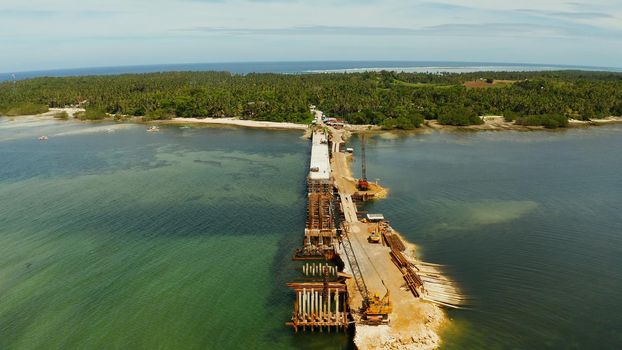 Construction of a new bridge over the sea bay on the tropical island of Siargao.