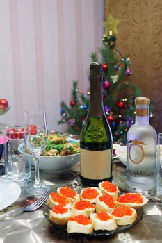 new year's holiday table set and decorated Christmas tree