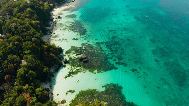 Tropical landscape turquoise lagoon and tropical beach from above. Seascape with beach on tropical island. Summer and travel vacation concept. Boracay, Philippines