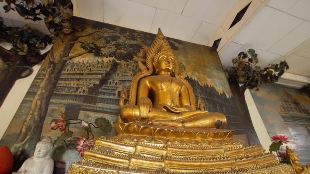 Statue of the Buddha god, Sacrifice oblation, traditional offerings for Gods in the Buddhist temple Brahma Vihara Indonesia. Bali Architecture, Ancient design. Travel concept.