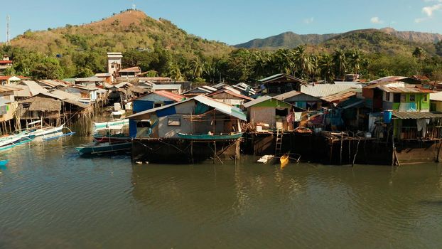 Old wooden house standing on the sea in the fishing village. Busuanga, Coron, Philippines. houses community standing in water in fishing village. Coron city with slums and poor district.