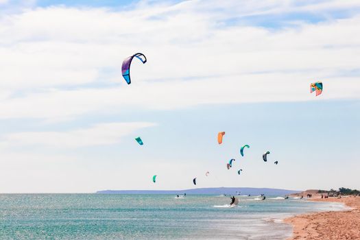 a kitesurfer surfing on the smooth azure water. recreational sport. A Man Rides A Kiteboarding In The Sea Water. extreme sport. High quality photo