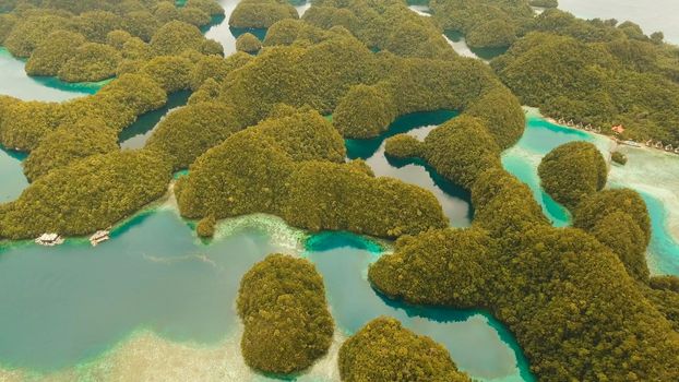 Aerial view: Bucas Grande Island, Sohoton Cove. Philippines. Tropical sea bay and lagoon, beach. Tropical landscape hill, clouds and mountains rocks with rainforest. Azure water of lagoon. Shore Landscape Bay. Aerial video.Seascape. Travel concept.