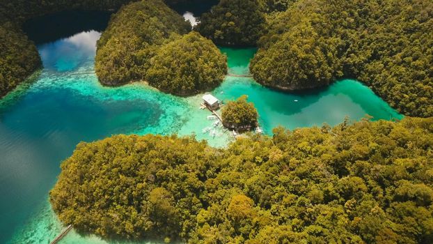 Aerial view: beach, tropical island, sea bay and lagoon, Siargao. Tropical landscape hill, clouds and mountains rocks with rainforest. Azure water of lagoon. Shore Landscape Bay. Travel concept.